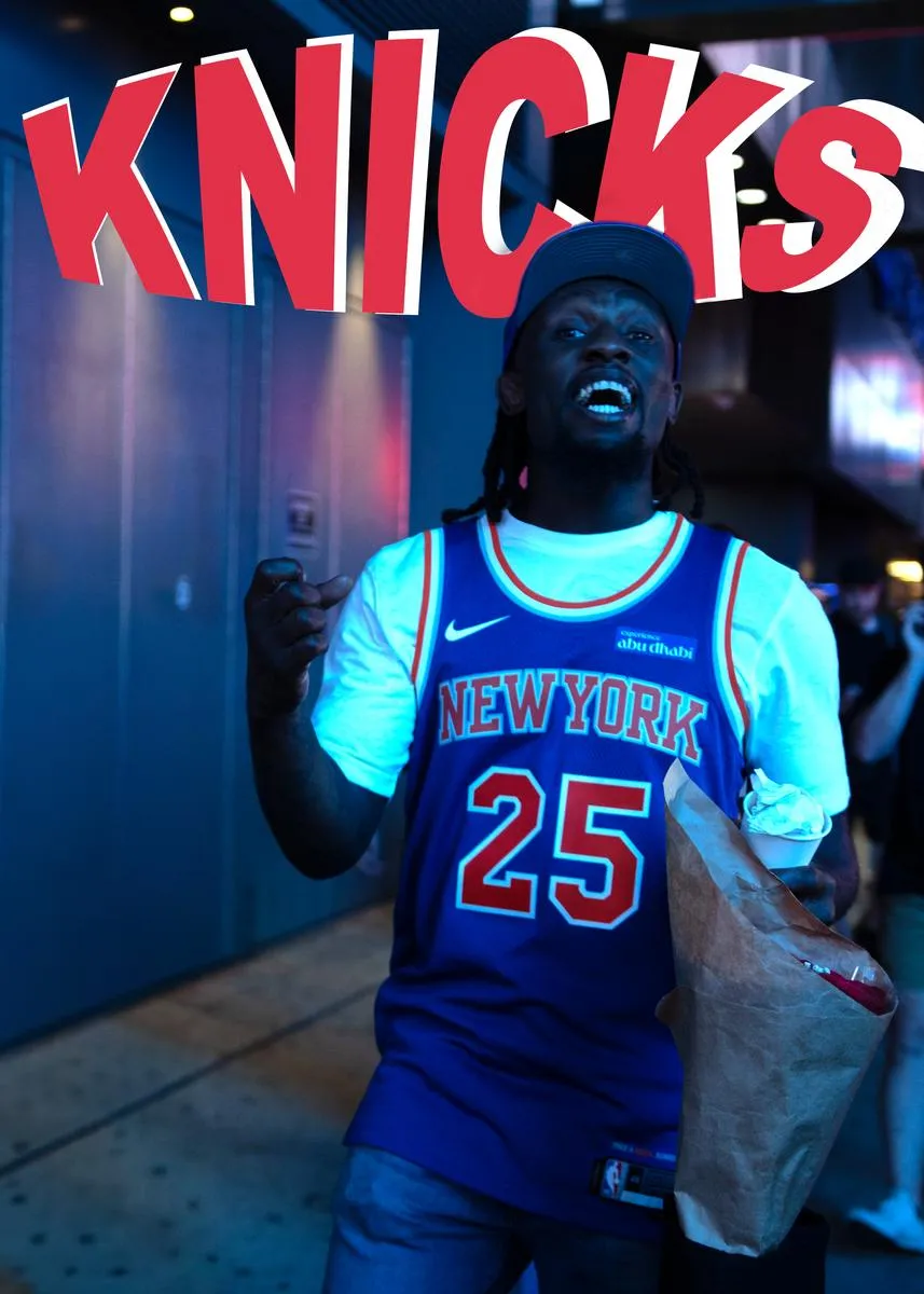 Passionate Knicks fan in number 25 jersey shouting with joy under neon KNICKS sign at night