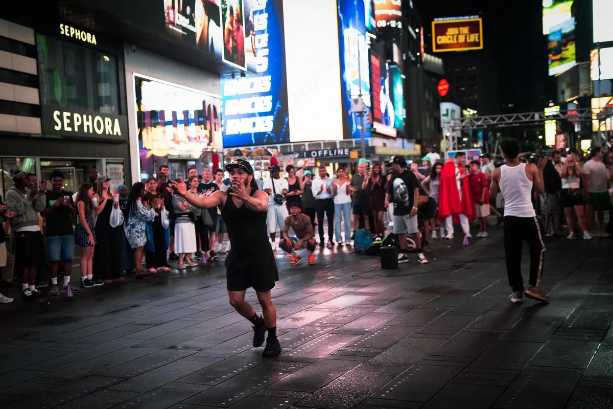 Street performer engaging crowd in Times Square at night with Sephora store and KNICKS billboard visible